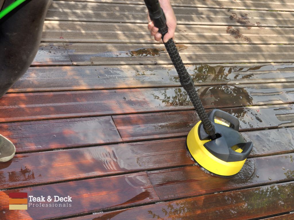 Scrub tough areas of wood deck