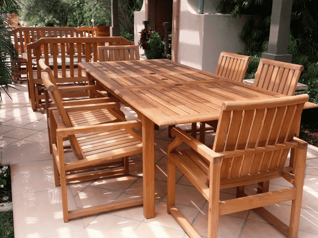 Teak patio furniture set in a garden setting, showcasing quality craftsmanship and durability for outdoor spaces